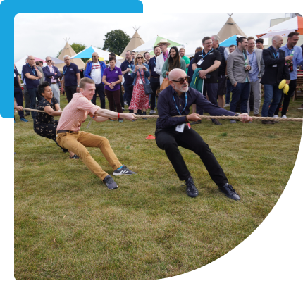 Our CEO and colleague playing tug of war in front of a crowd at an awards ceremony outside