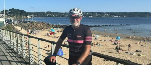 Tony Summers, CEO of Socitm Advisory, at Brest beach in France. He is holding his bike. He was completing the Paris to Brest to Paris cycle challenge. This was the half way point.