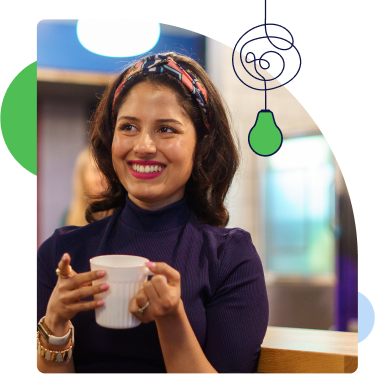 A female colleague smiling holding a cup of coffee